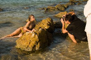 Brooklyn Decker laying on a beach rock for a photosession outdoors