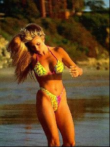 linda sobek on the beach wearing a pink and yellow bikini.