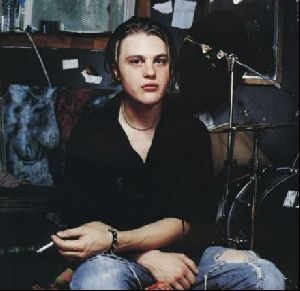 Actor michael pitt photo beside a drums with a cigerrette in his hand