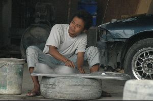 Cities thailand : A Thai car mechanic working in a car body repairshop. Bangkok