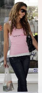 Jessica Alba in a pink top and black pants