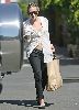 Actress  Ashley Olsen pictures wearing a see through white shirt with a bra under it