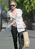 Actress  Ashley Olsen pictures wearing a see through white shirt with a bra under it