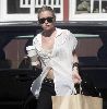 Actress  Ashley Olsen pictures wearing a see through white shirt with a bra under it