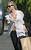 Actress  Ashley Olsen pictures wearing a see through white shirt with a bra under it