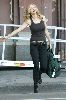 Actress Heather Graham pictures wearing a black tight tank top, tight jeans and pair of sexy leather