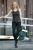 Actress Heather Graham pictures wearing a black tight tank top, tight jeans and pair of sexy leather