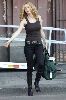 Actress Heather Graham pictures wearing a black tight tank top, tight jeans and pair of sexy leather