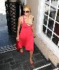 Paris Hilton pictures wearing a pink dress with a black sunglasses