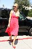 Paris Hilton picture wearing a pink dress with a black sunglasses