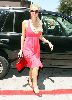 Paris Hilton picture wearing a pink dress with a black sunglasses