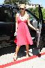 Paris Hilton picture wearing a pink dress with a black sunglasses