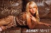 Ashley Tisdale signiture on a photo shoot while resting on a brown couch