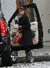 Jessica Alba wearing a black coat and a red rose hat in Los Angeles on December 18th 2007