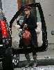 Jessica Alba wearing a black coat and a red rose hat in Los Angeles on December 18th 2007