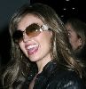 Thalia in large dark brown sunglasses