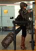 Tila Tequila spotted at the airport wearing a gray jacket over black leggings and tall sugar brown boots