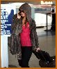 Tila Tequila spotted at the airport wearing a gray jacket over black leggings and tall sugar brown boots