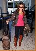 Tila Tequila spotted at the airport wearing a gray jacket over black leggings and tall sugar brown boots