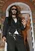 Russell Brand : Russell Brand stands outside his own house in England