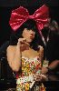 Katy Perry : On stage performing with a big red ribbon on her hair