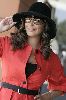 Elissa : in a red coat, large black hat and sunglasses