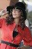 Elissa : elissa weaing a red coat, large black hat and sunglasses