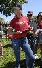 Christy Brinkley : showing her red artist shirt while on the field of the Artists and Writers annual Softball game