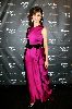 Olga Kurylenko : Olga picture on the red carpet wearing a dark pink dress with a black waist ribbon at the Quantum of Solace in Amsterdam movie Premiere