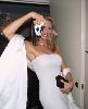 Christy Brinkley : Christie in a stunning long white dress holding a a camera