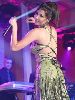 Nancy Ajram : nancy dancing on stage wearing a green dress