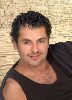 Ragheb Alama : wearing a black top