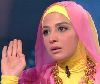 Hanan Turk : Hanan in a TV interview wearing a pink and yellow scarf