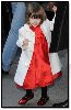 Suri Cruise : Suri is stylish again with her White Coat on the red dress and the Ballet Flat red shoes