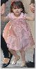 Suri Cruise : red hair ribbon and pink nit chest dress and a golden ballerina flast shoes