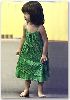 Suri Cruise : this green dress had no matching shoe, so Suri decided to go bare footed, what a cutie