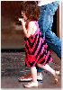 Suri Cruise : pink striped dress matched with her golden flats