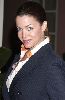 Claudia Christian : looking formal in a gray suit jacket