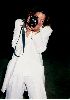 Claudia Christian : Claudia Christian in a white outfit shooting a video with her camera