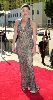 Claudia Christian : on the red carpet wearing a beige dress with navy knits