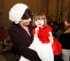 Suri Cruise : Katie Holmes who just turned 30 years old yesterday is holding her daughter Suri who is wearing a red dress