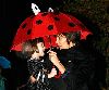 Suri Cruise : Katie Holmes takes Suri for a walk on a rainy day and makes a stop at baby gap in New York City