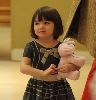 Suri Cruise : Suri looks cute holding her stuffed pink bunny toy