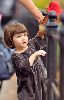 Suri Cruise : little Suri Cruise playing with her stuffed bear, dressed wearing a grey velvet dress having in Union Square Park. She was accompanied by mom Katie and bodyguards