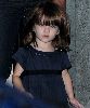 Suri Cruise : the 2 years old celebrity is wearing navy dress with gems and looking directly at the camera