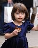 Suri Cruise : Suri holding her mom s hand is eating a chocolate candy sprinkled cupcake on the streets of Manhattan on November 24, 2008 in New York City