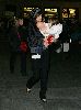 Suri Cruise : Suri with her baby doll is carried by her mother