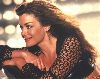 Claudia Christian : claudia christian loose light brown hair, wearing a showthrough knit black shoulders jacket