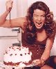 Claudia Christian : looking evil as she is about to stab a strawberry chocolate cake in one of the studio photo sessions