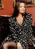 Claudia Christian : in a black printed old-style dress that shoes her cleavage